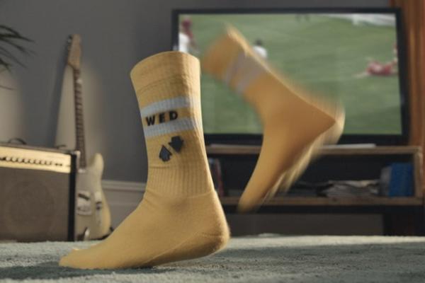 a yellow sock with black letters and a black and white sock on it