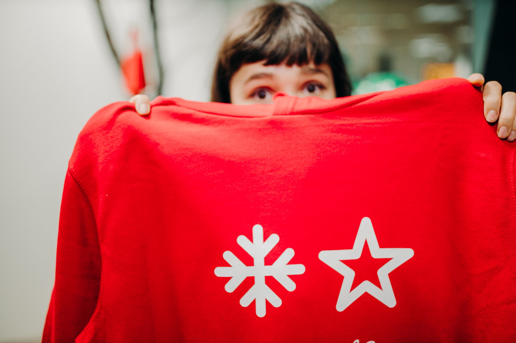a person holding a red shirt