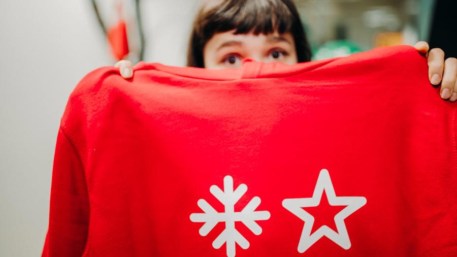 a person holding a red shirt